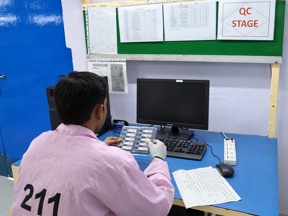 A Syrotech technician checking modules at the QC stage